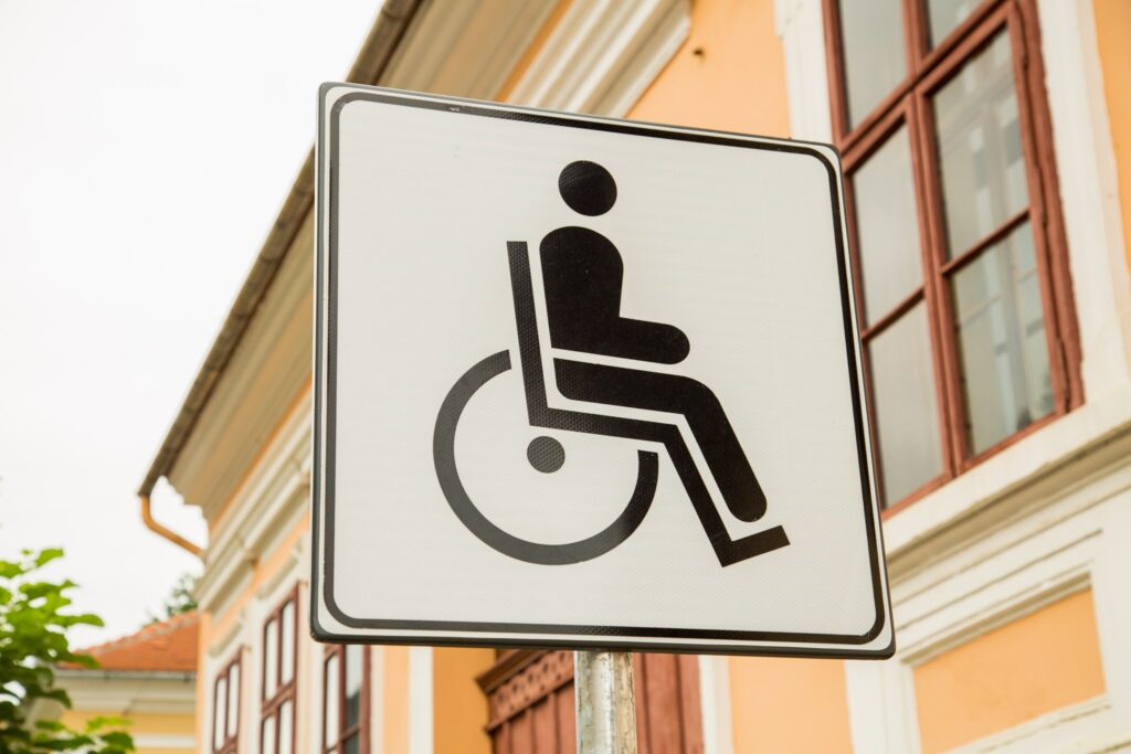 The World is Accessible. Image of a disabled parking sign, with the international symbol for a disabled person - the outline of a person sitting in a wheelchair. Accessible World.
