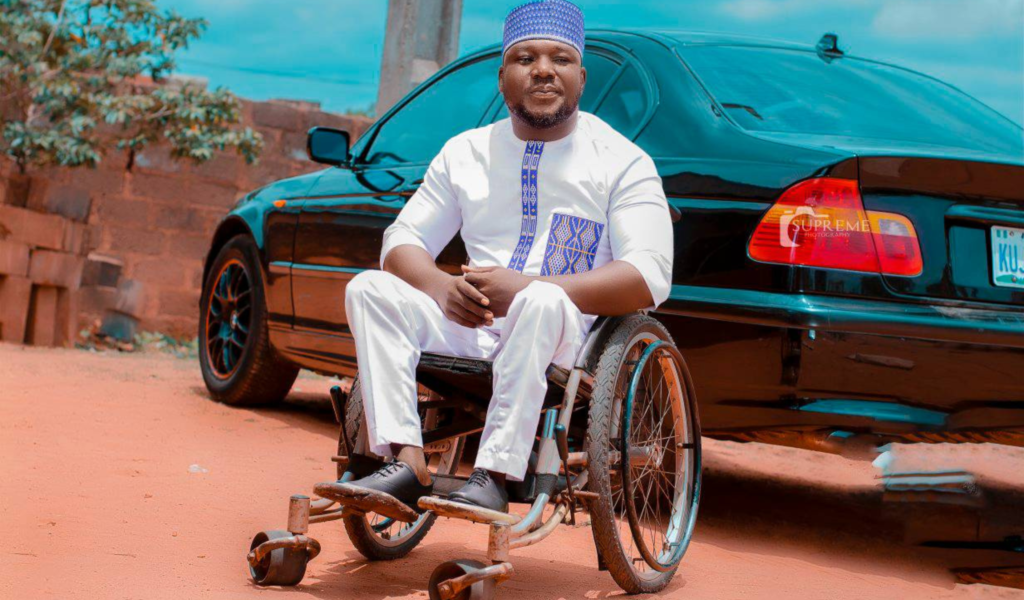 Disability Access in Nigeria - Smart JP in front of car.