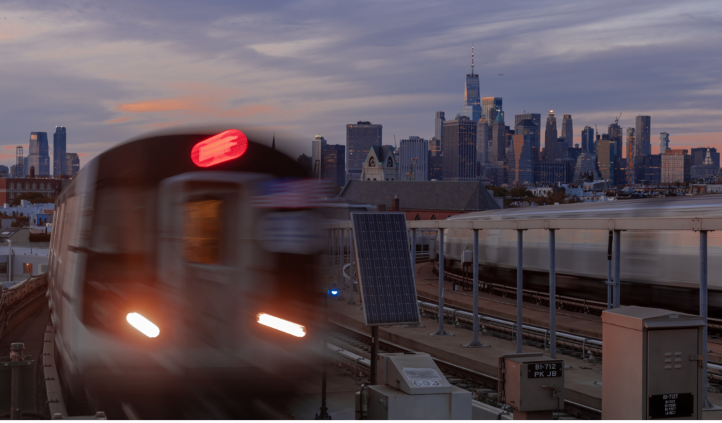 Wheelchair-friendly NYC Itinerary - train with city view behind it. 