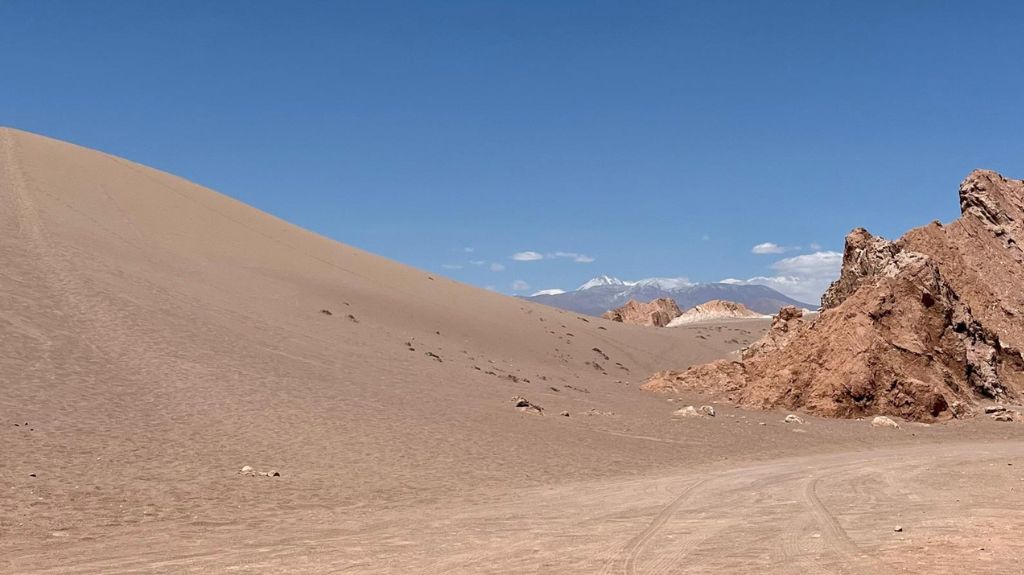 Sand Dune in the Valley of Mars. Very sparse. Nothing but sand and blue sky.