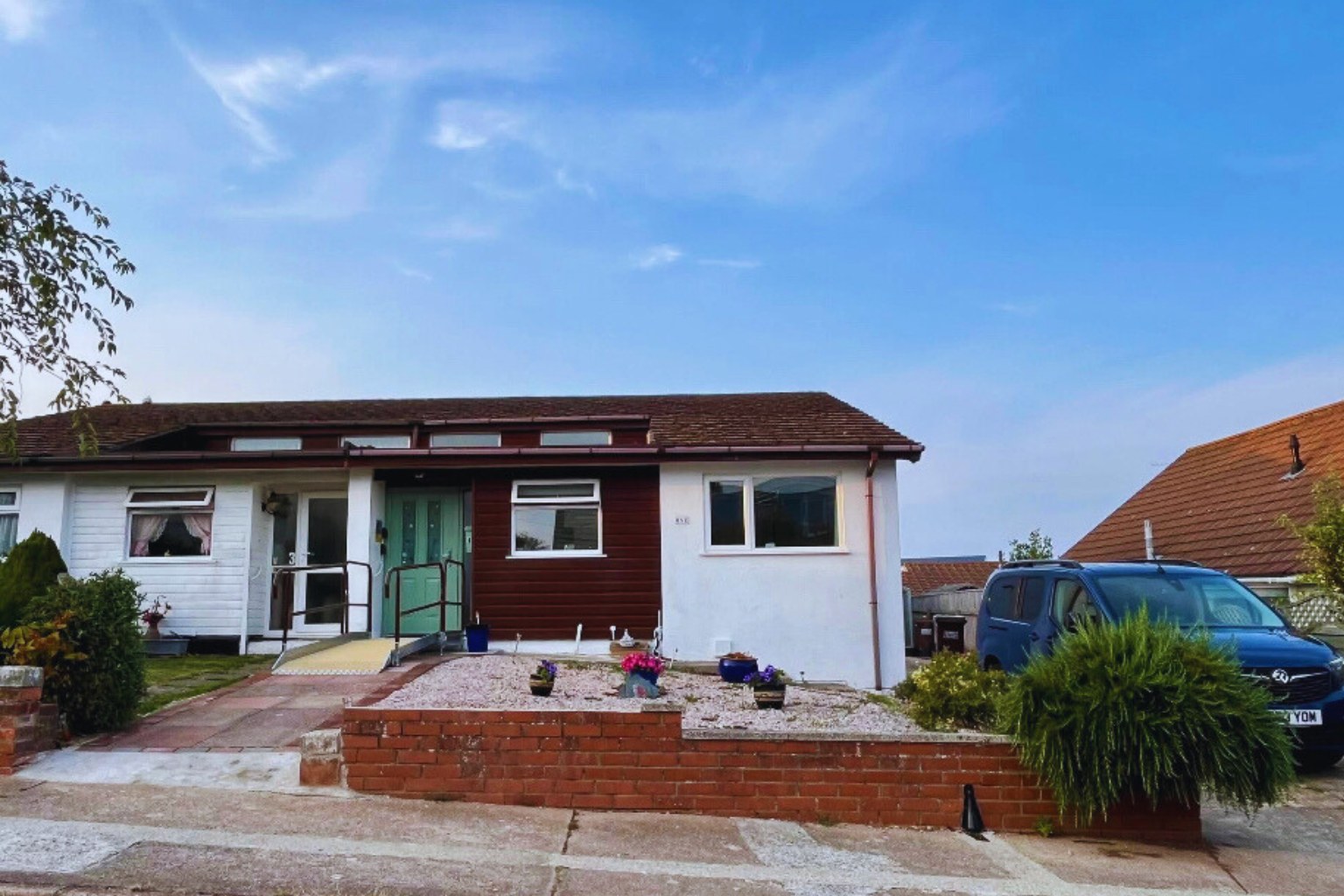 Seahorse, a wheelchair accessible holiday bungalow in Brixham, Devon, with step-free ramp entrance and driveway parking for WAVs.