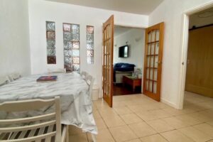 Wheelchair-accessible dining area at Seahorses holiday bungalow in Brixham, with extendable table and step-free access to lounge.