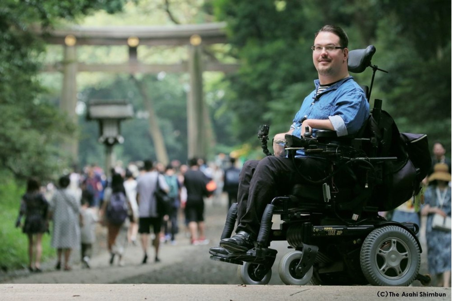 Josh Grisdale, a wheelchair user and accessibility advocate, at Meiji Shrine in Tokyo, highlighting Japan’s accessible travel community.