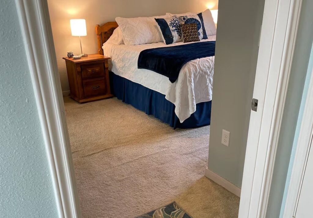 Step-free bedroom with wide doorway and king-size bed in accessible Galveston rental.