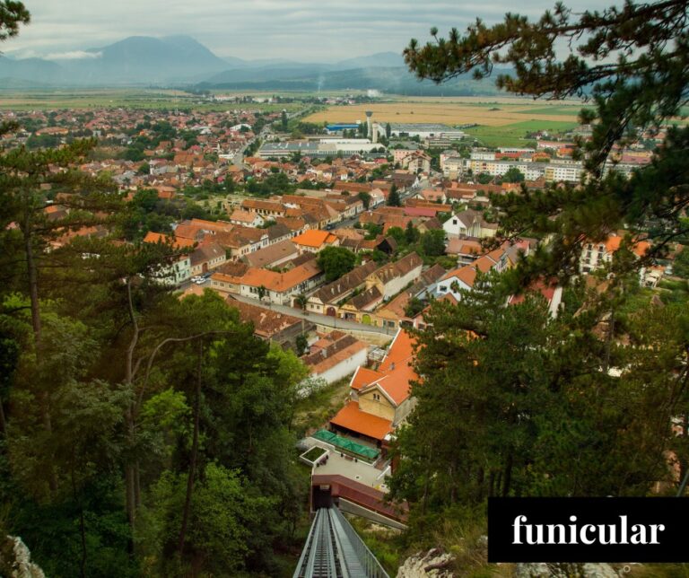 View from Râșnov Citadel looking down the wheelchair accessible funicular over the rooftops of Râșnov town, Transylvania, Romania