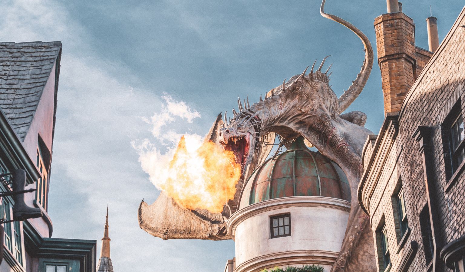 Fire-breathing dragon sculpture atop Gringotts Bank at the Wizarding World of Harry Potter, Universal Studios Hollywood – accessible Los Angeles theme park guide