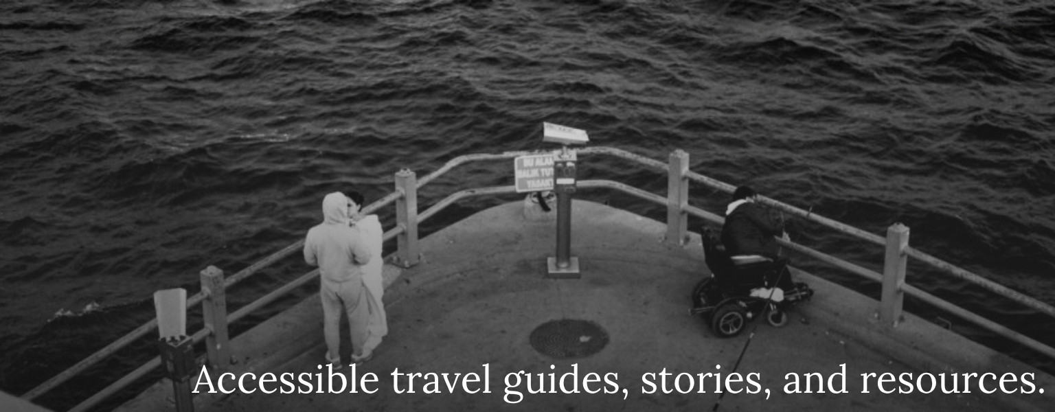 A wheelchair user sits on a pier, looking out to sea. The World is Accessible. Text reads: Accessible travel guides, stories, and resources.