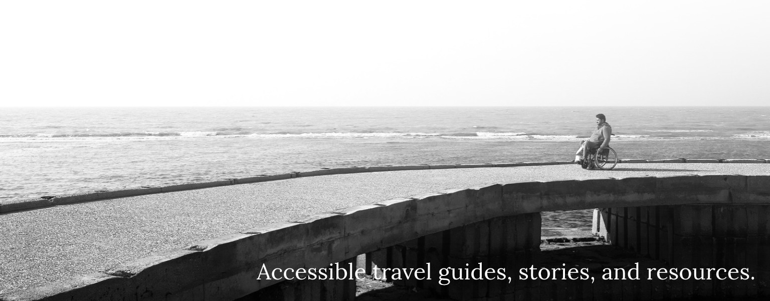 A wheelchair user enjoying an accessible pier, representing The World is Accessible's mission of inclusive travel